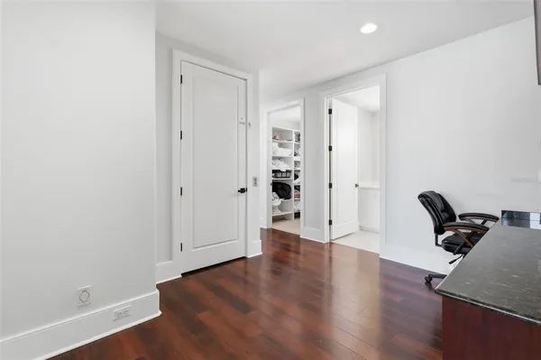 a large white kitchen with a large window