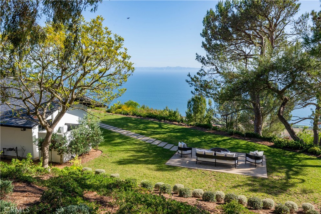 71 Crest Road East Rolling Hills, CA 90274 - Photo 13 of 23 a view of a swimming pool with lawn chairs and plants