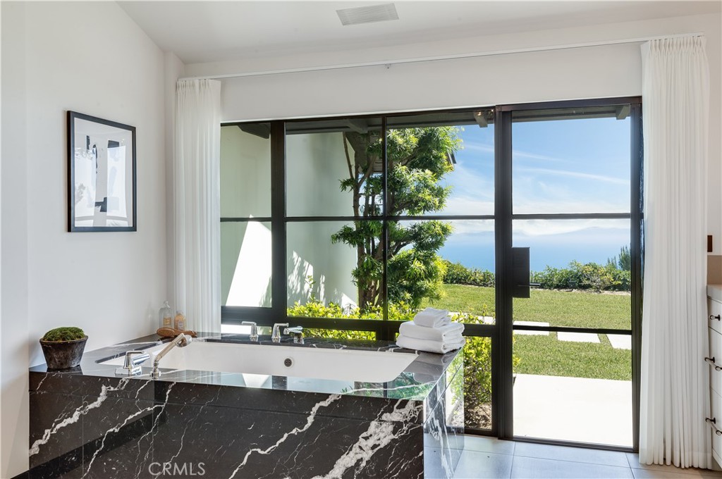 71 Crest Road East Rolling Hills, CA 90274 - Photo 14 of 23 a room with a large window and a table