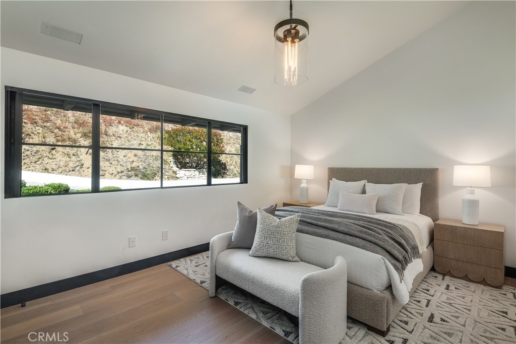71 Crest Road East Rolling Hills, CA 90274 - Photo 15 of 23 a bedroom with a bed and a large window