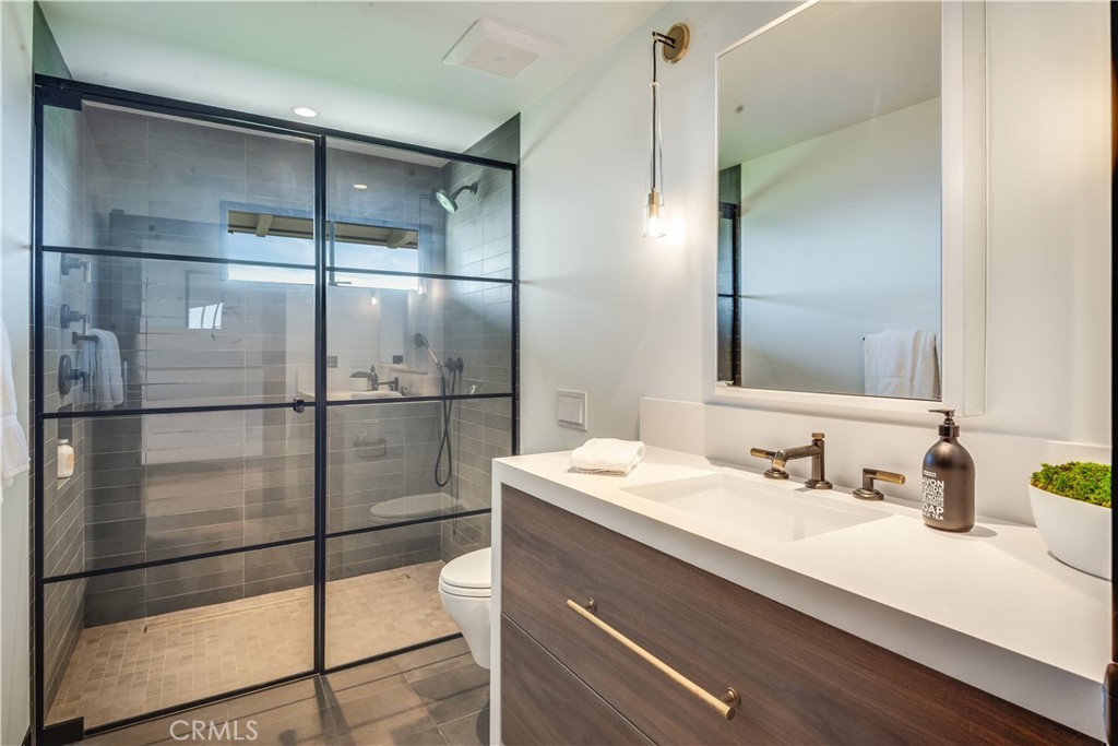 71 Crest Road East Rolling Hills, CA 90274 - Photo 18 of 23 a bathroom with a shower sink and mirror