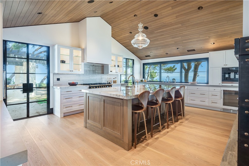 71 Crest Road East Rolling Hills, CA 90274 - Photo 7 of 23 a kitchen with stainless steel appliances kitchen island granite countertop a stove and a cabinets