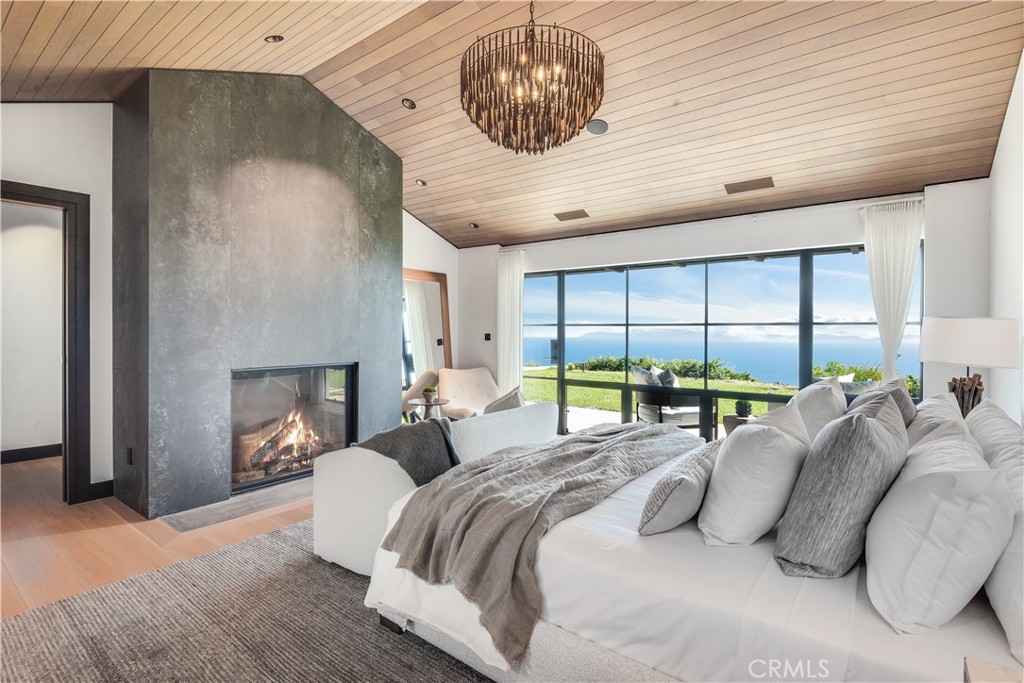 71 Crest Road East Rolling Hills, CA 90274 - Photo 9 of 23 a bedroom with a bed and a large window