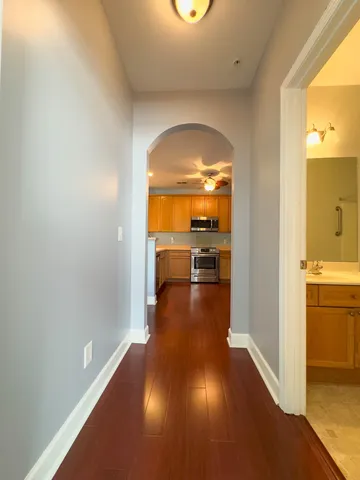 a view of a kitchen from a hallway