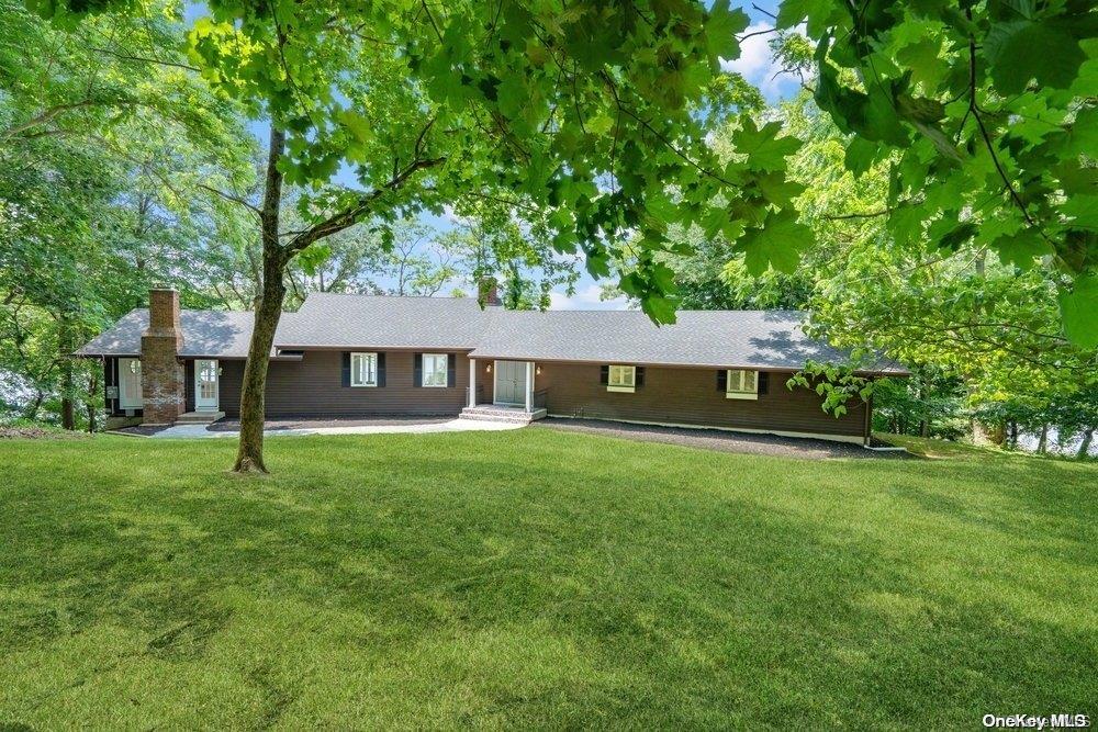 432 River Road Nissequogue, NY 11780 - Photo 1 of 1 a front view of a house with garden