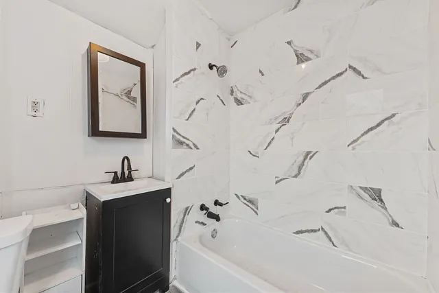 a bathroom with a bathtub and a sink