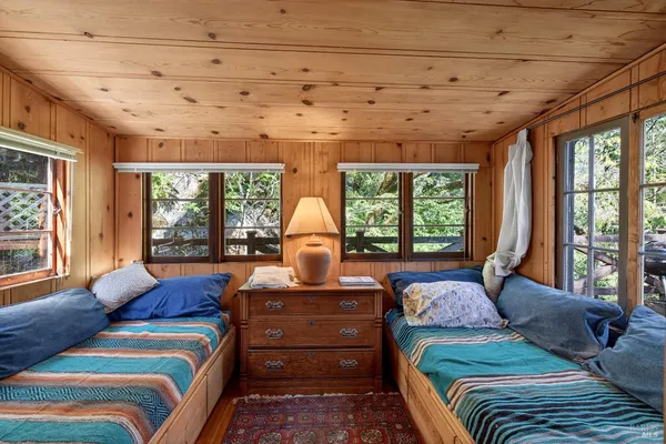 a living room with furniture and large windows