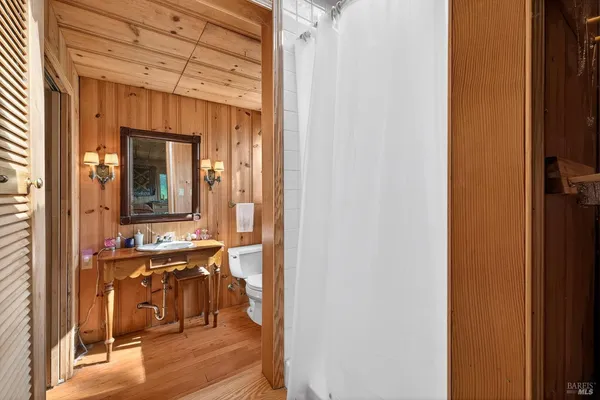 a view of a room that has a bed and a table in it