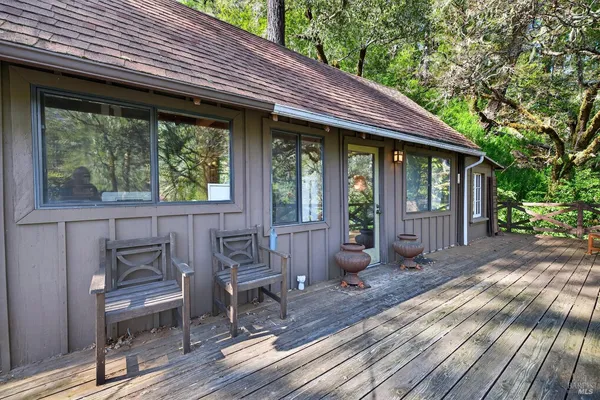 a view of house with backyard outdoor seating and wooden floor