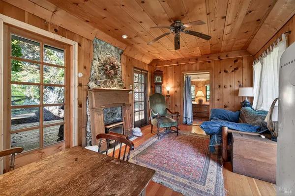 a living room with furniture a fireplace and a table