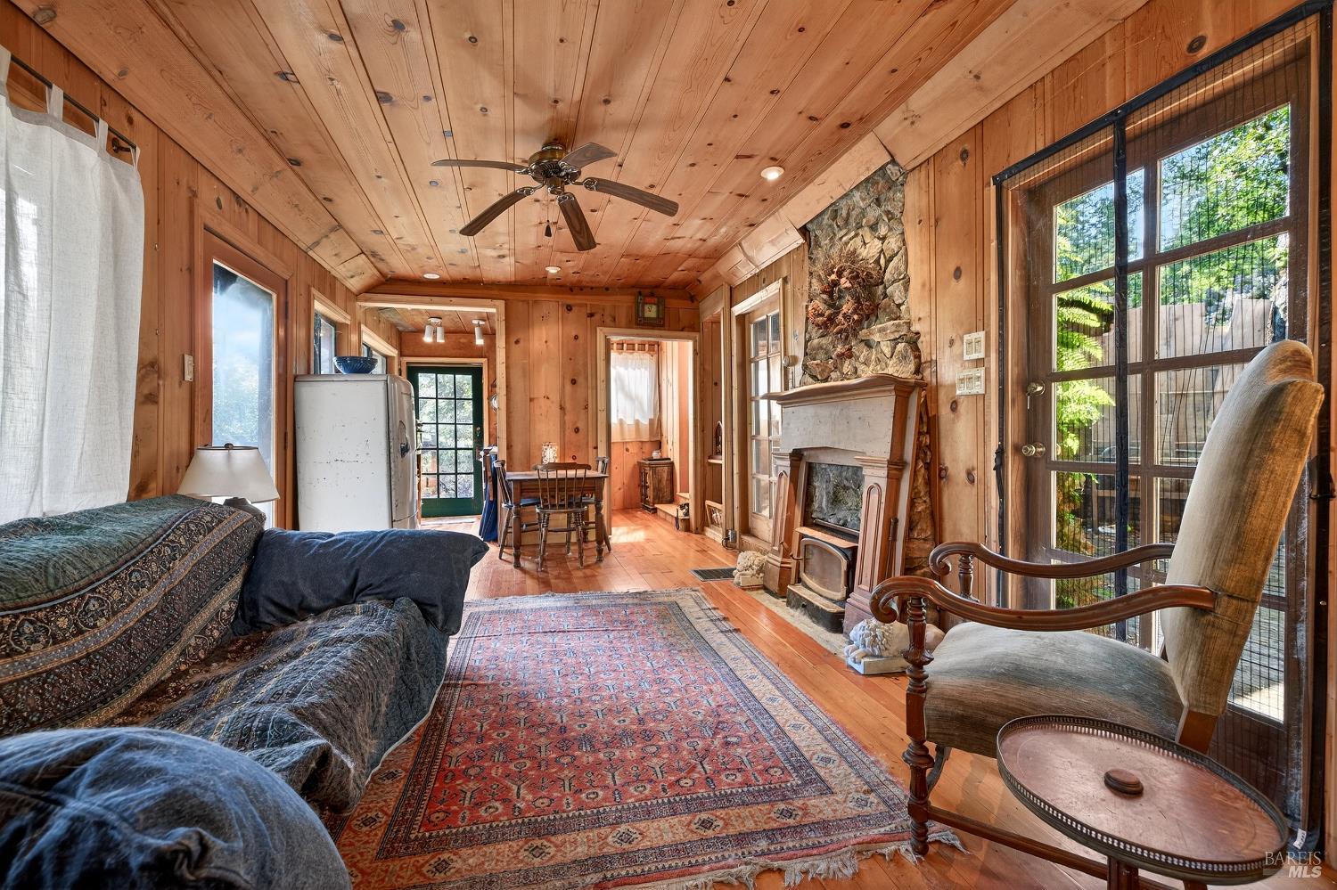 5925 Austin Creek Road Cazadero, CA 95421 - Photo 8 of 21 a living room with furniture a flat screen tv and a large window