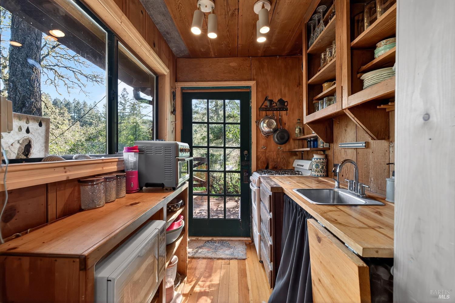 5925 Austin Creek Road Cazadero, CA 95421 - Photo 9 of 21 a view of a kitchen with furniture and windows