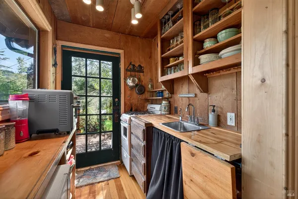a open kitchen with granite countertop a sink and a refrigerator