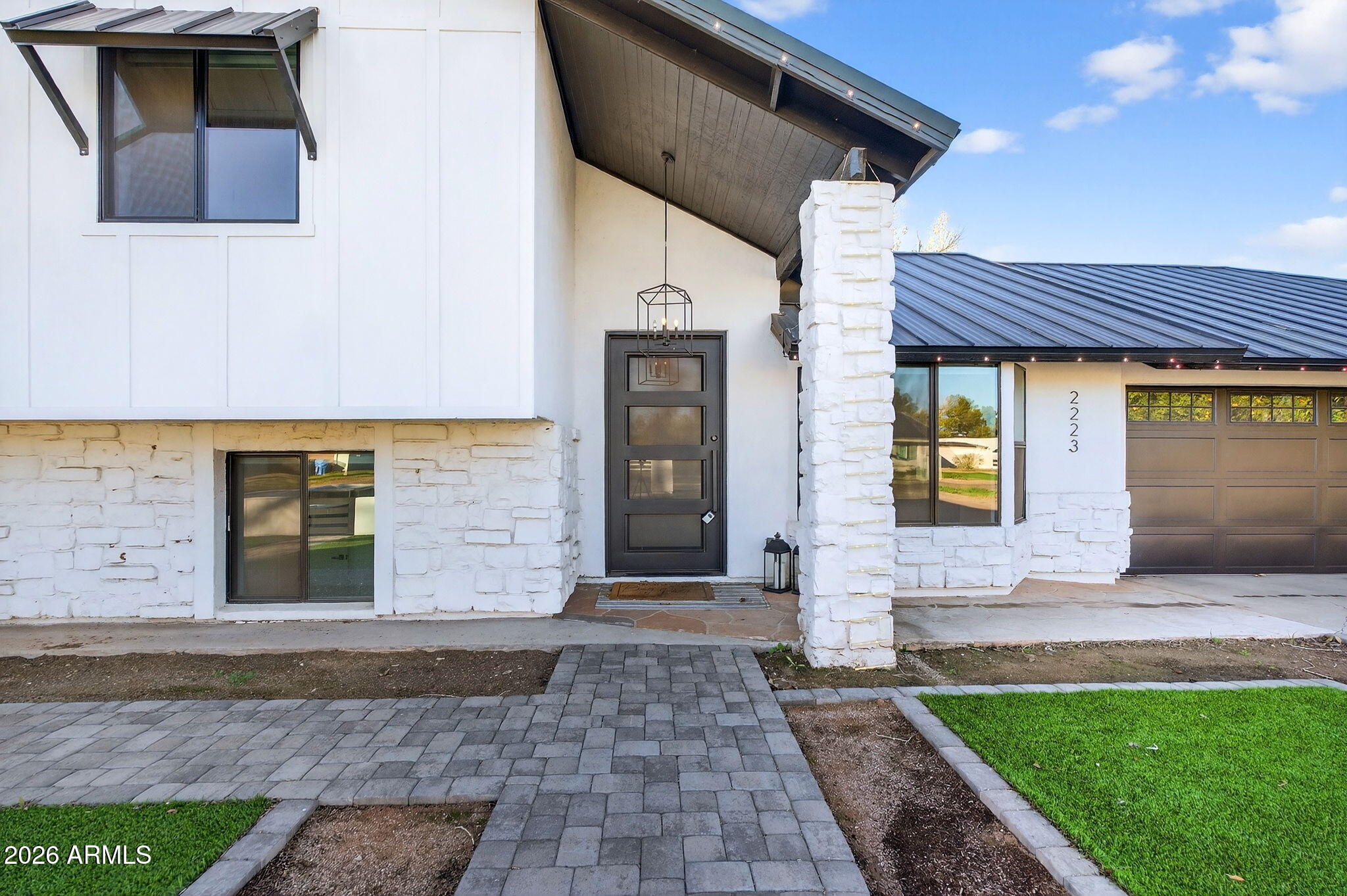 2223 East Claxton Avenue Gilbert, AZ 85297 - Photo 7 of 56 a front view of a house with a yard