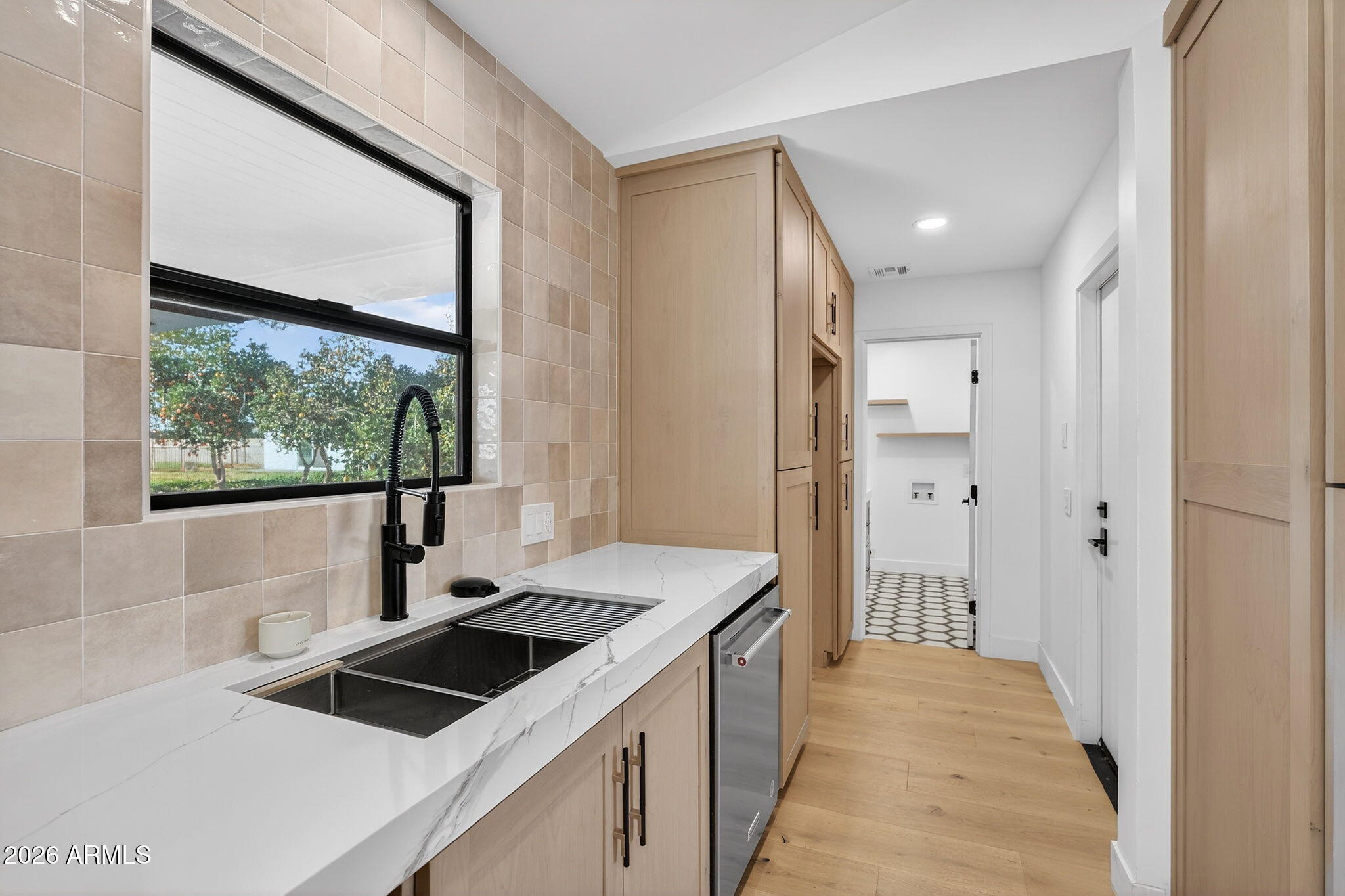 2223 East Claxton Avenue Gilbert, AZ 85297 - Photo 13 of 56 a kitchen that has a sink a stove and a wooden floor