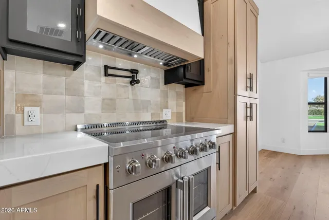 a large kitchen with kitchen island a sink stainless steel appliances and cabinets