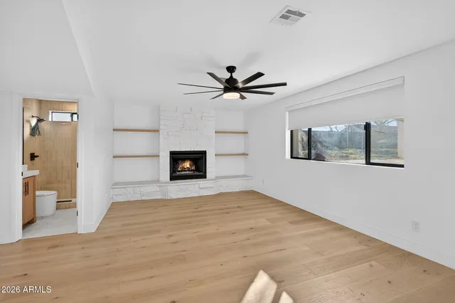 a kitchen that has a sink a stove and a wooden floor