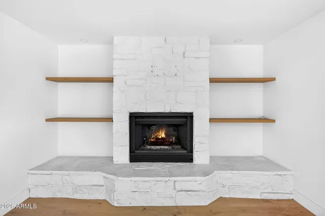 a view of empty room with wooden floor and a ceiling fan