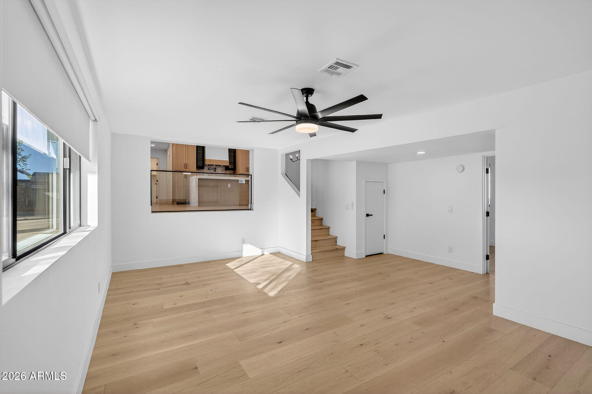 2223 East Claxton Avenue Gilbert, AZ 85297 - Photo 19 of 56 a view of empty room with wooden floor and ceiling fan