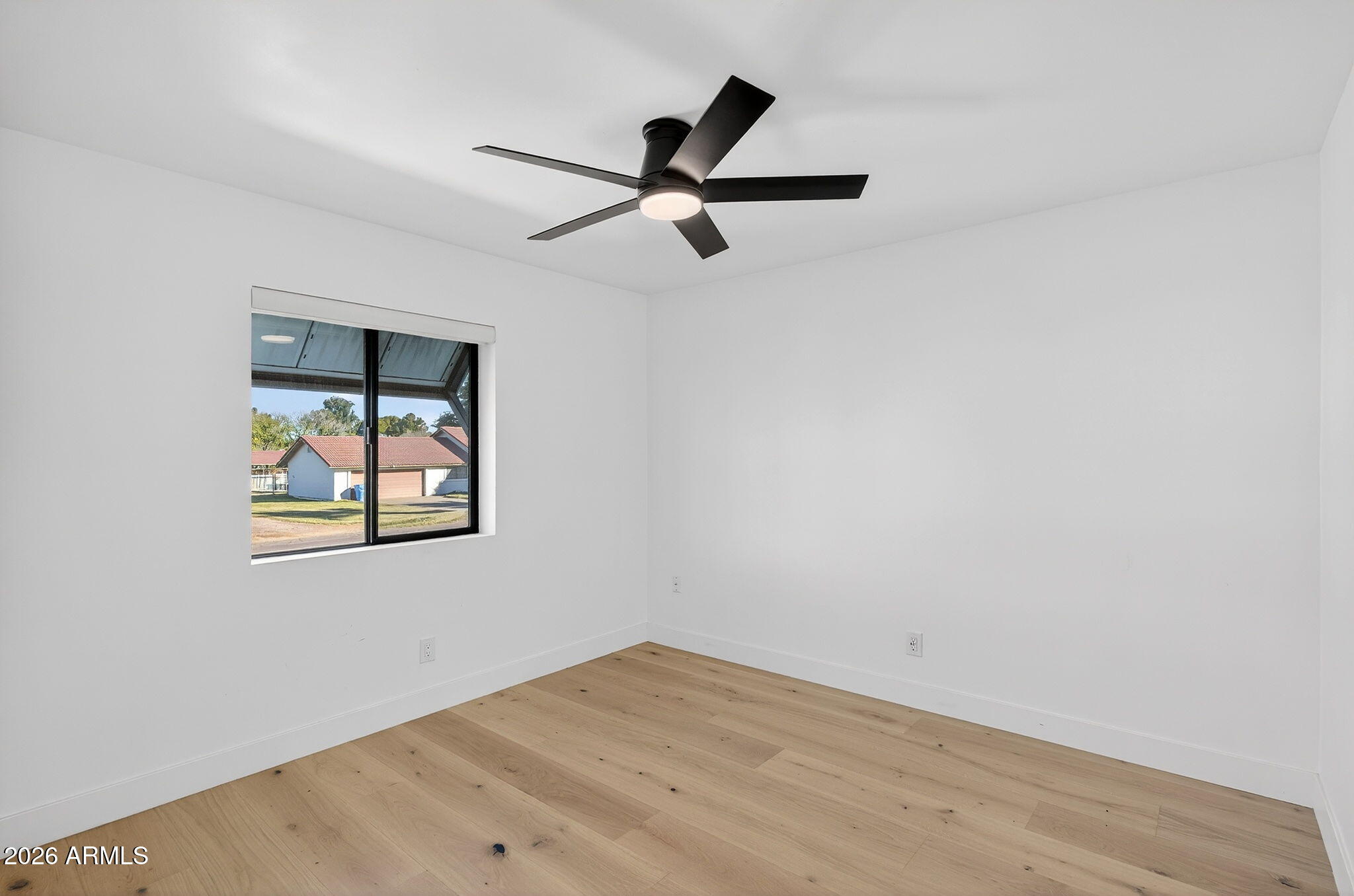 2223 East Claxton Avenue Gilbert, AZ 85297 - Photo 27 of 56 a view of empty room with wooden floor and ceiling fan
