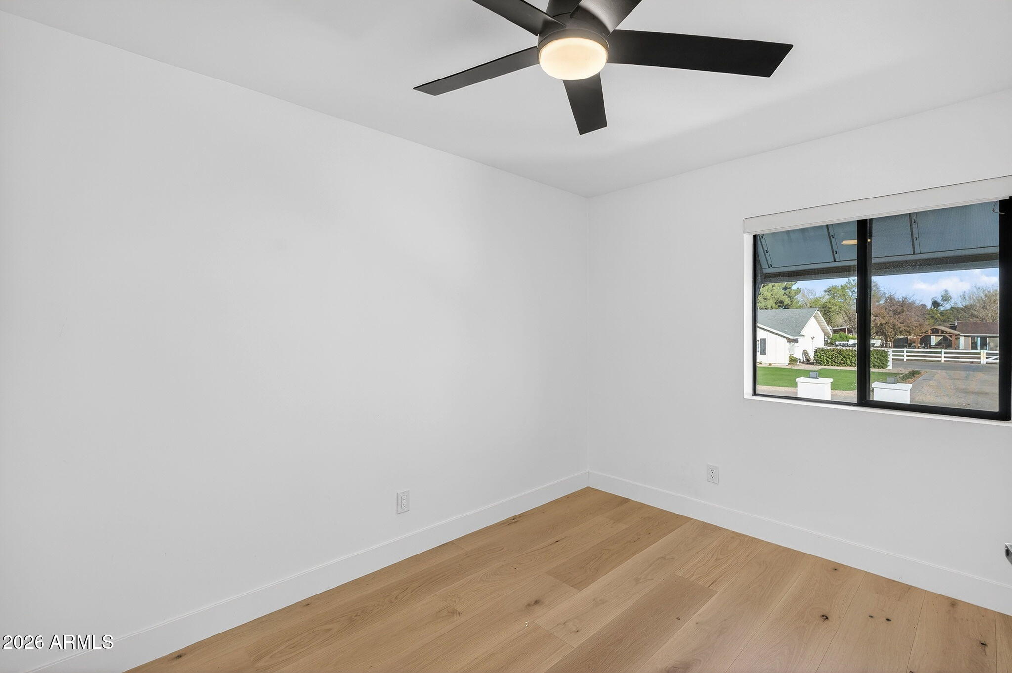 2223 East Claxton Avenue Gilbert, AZ 85297 - Photo 28 of 56 an empty room with a window and a ceiling fan