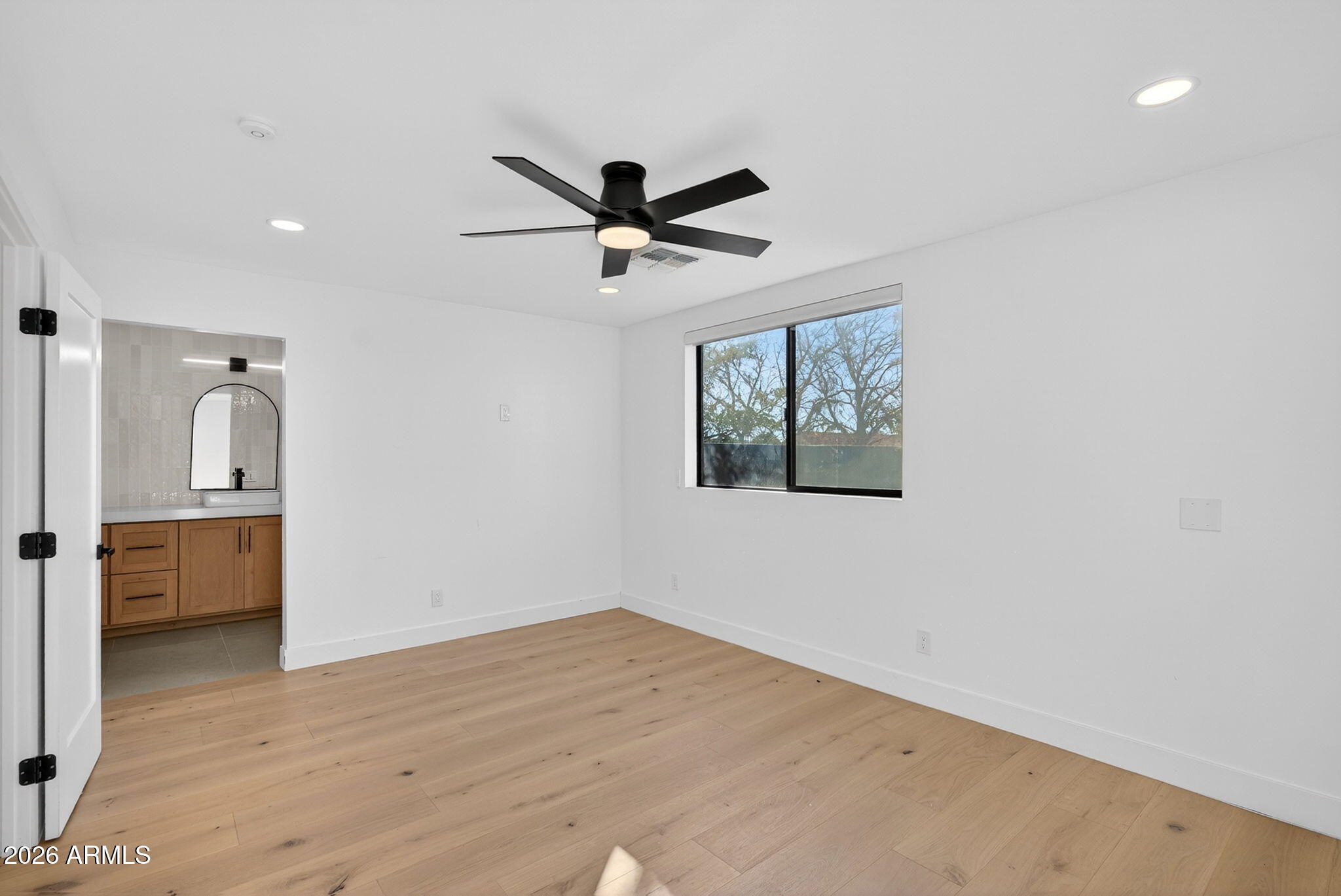 2223 East Claxton Avenue Gilbert, AZ 85297 - Photo 29 of 56 a view of empty room with wooden floor and ceiling fan