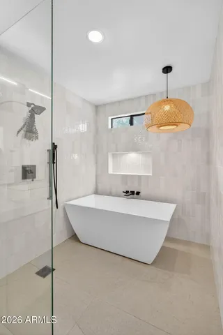 a bathroom with a bathtub and a shower