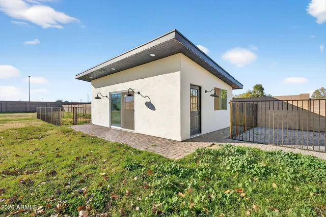 a view of a backyard with a garden and deck