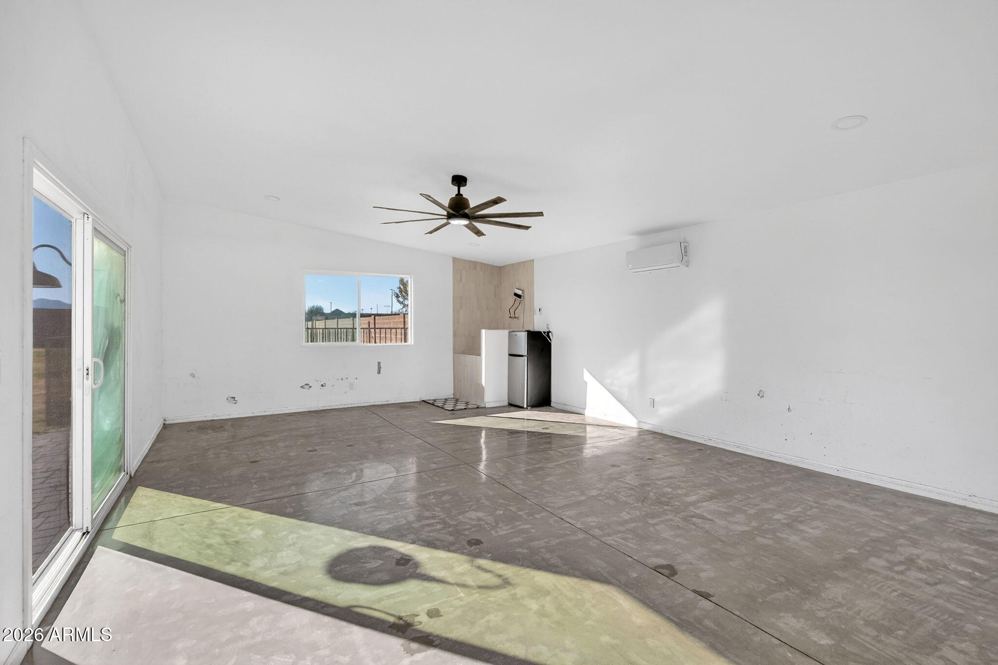 2223 East Claxton Avenue Gilbert, AZ 85297 - Photo 37 of 56 an empty room with a empty space and chandelier fan