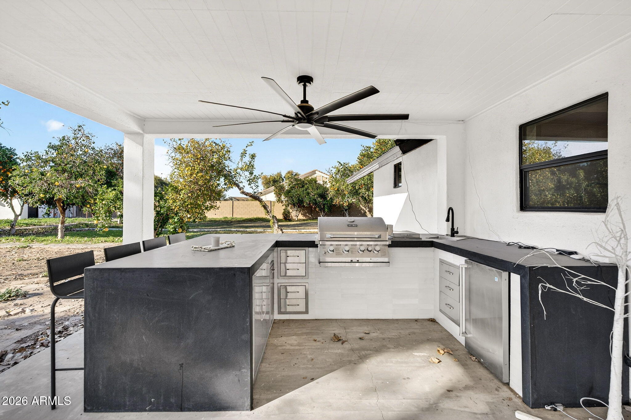 2223 East Claxton Avenue Gilbert, AZ 85297 - Photo 44 of 56 a kitchen with a sink and a stove