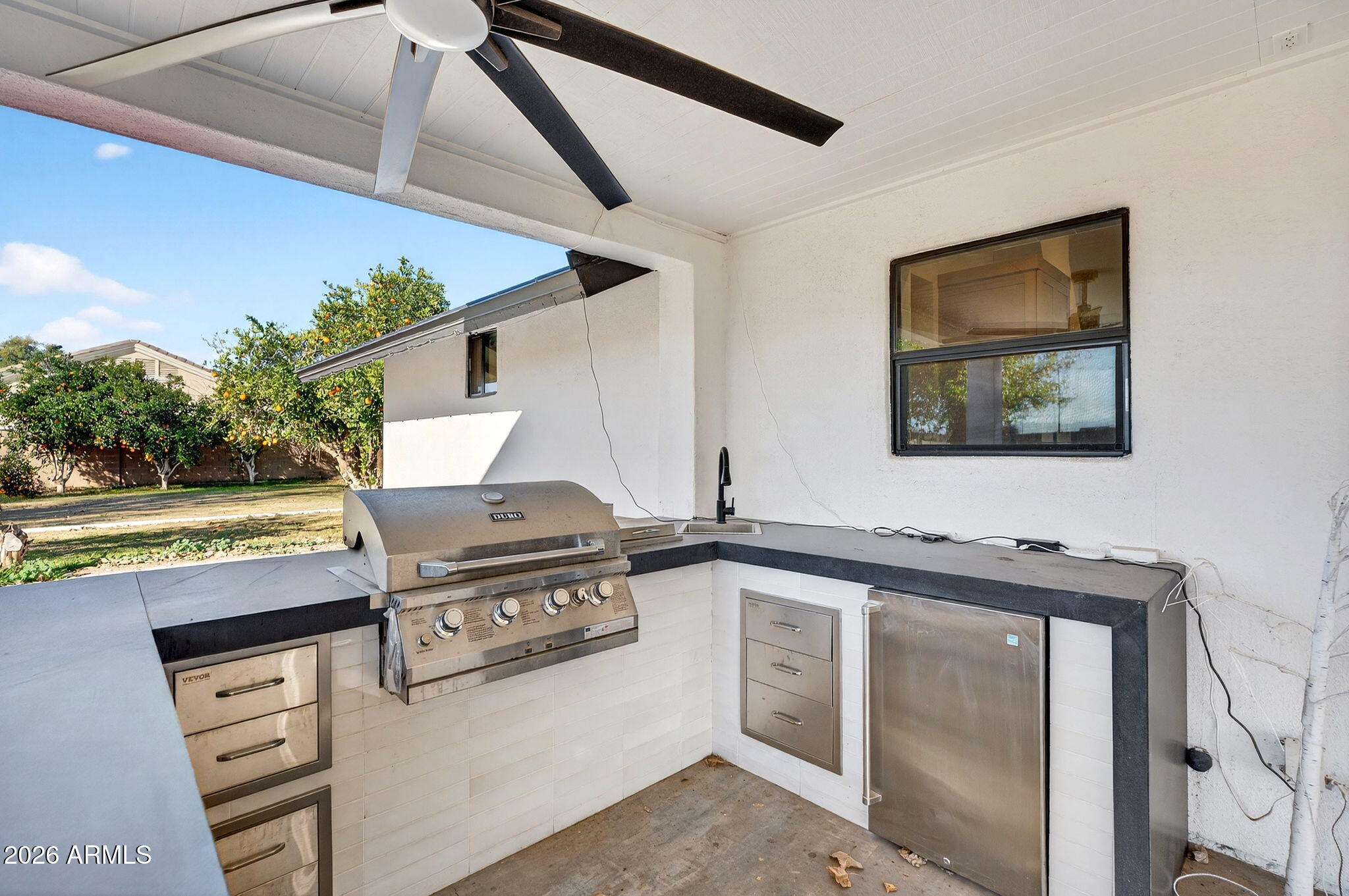 2223 East Claxton Avenue Gilbert, AZ 85297 - Photo 45 of 56 a open kitchen with stainless steel appliances granite countertop a stove and a sink