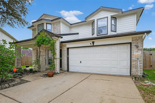 a front view of a house with a garage