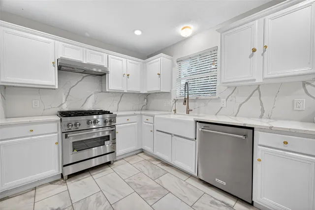 a kitchen with cabinets appliances and a sink