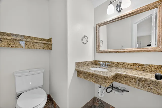 a bathroom with a sink toilet and mirror