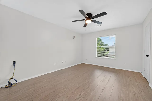 a view of a room with wooden floor and windows