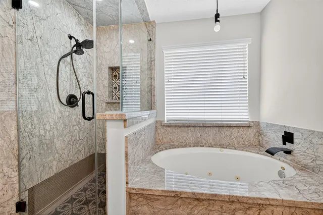 a bathroom with a bath tub and shower