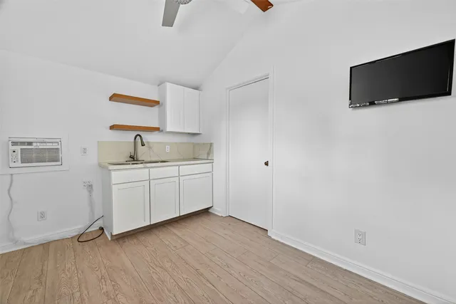 a view of a kitchen with wooden floor and sink