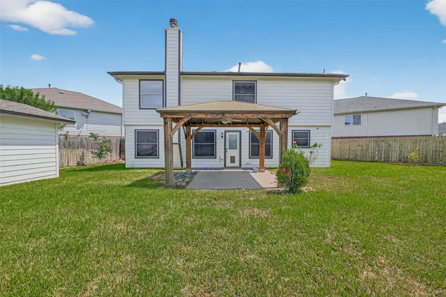 a view of a house with a yard and front view of a house