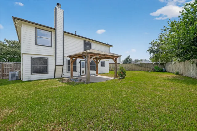 a view of a house with a yard and sitting area