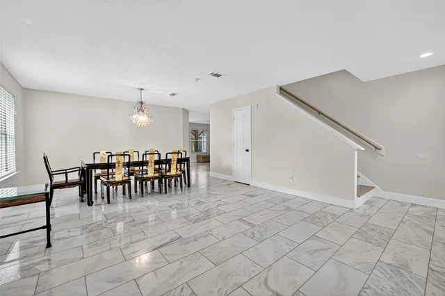 a view of a dining room with furniture and window
