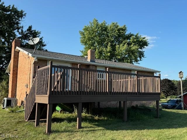 23656 Sandy Creek Road Minerva, OH 44657 - Photo 17 of 19 Back of house featuring a wooden deck and a lawn