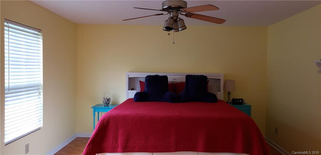 4489 Norfleet Street Concord, NC 28025 - Photo 12 of 23 a bed sitting in a bedroom next to a window