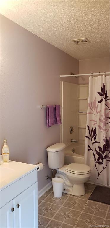 4489 Norfleet Street Concord, NC 28025 - Photo 13 of 23 a white toilet sitting next to a bathroom sink and a shower