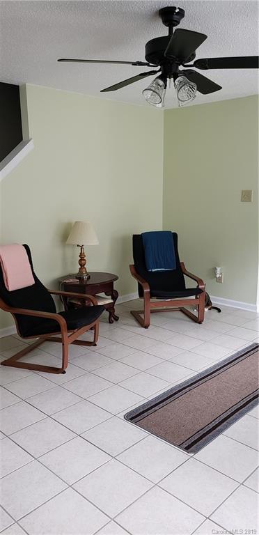 4489 Norfleet Street Concord, NC 28025 - Photo 7 of 23 a living room with a furniture a rug and white walls