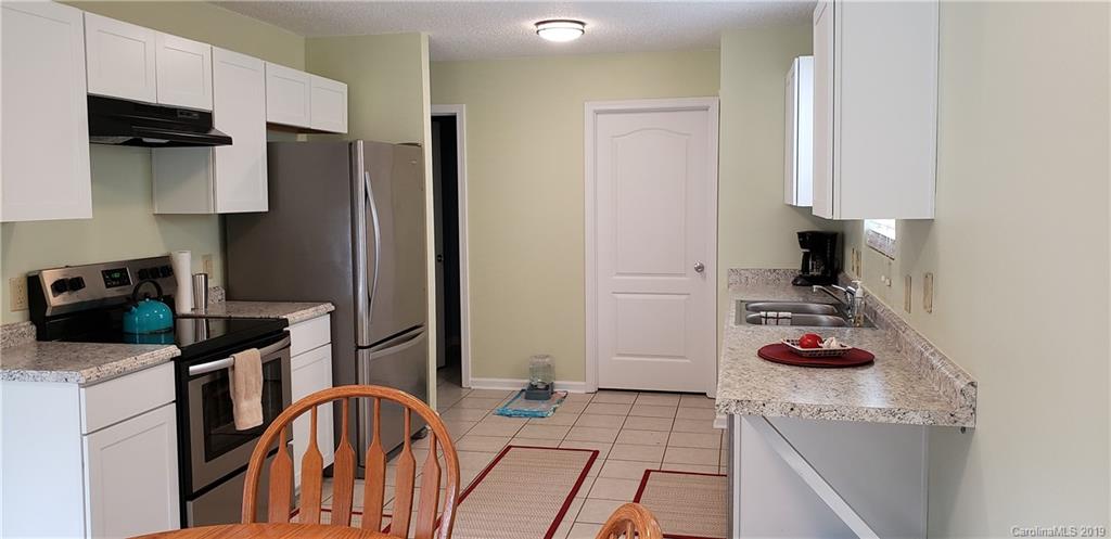 4489 Norfleet Street Concord, NC 28025 - Photo 8 of 23 a kitchen with stainless steel appliances granite countertop a refrigerator and a stove