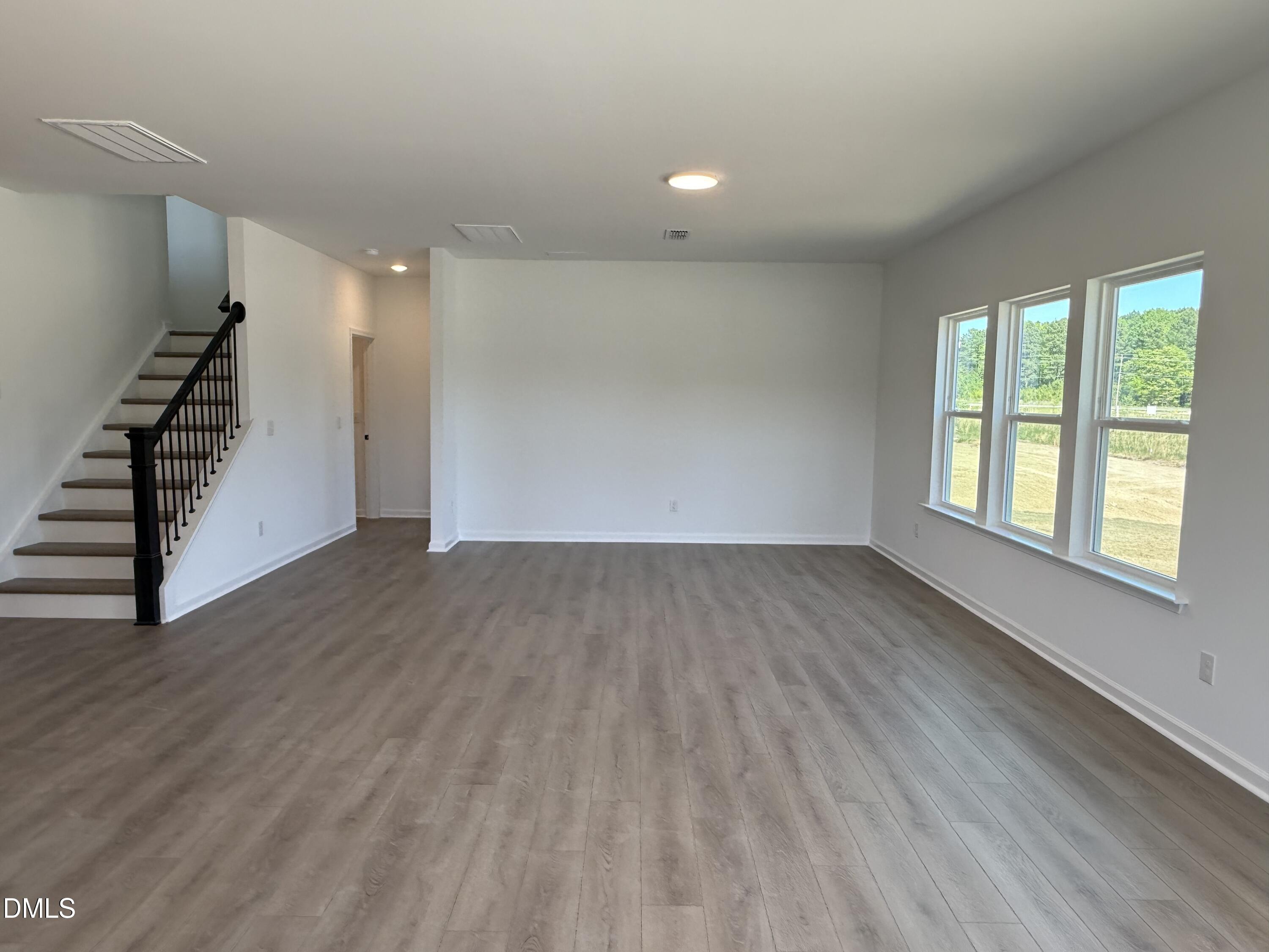 433 Contempo Court, Unit 3 Rolesville, NC 27571 - Photo 11 of 40 wooden floor in an empty room with a window