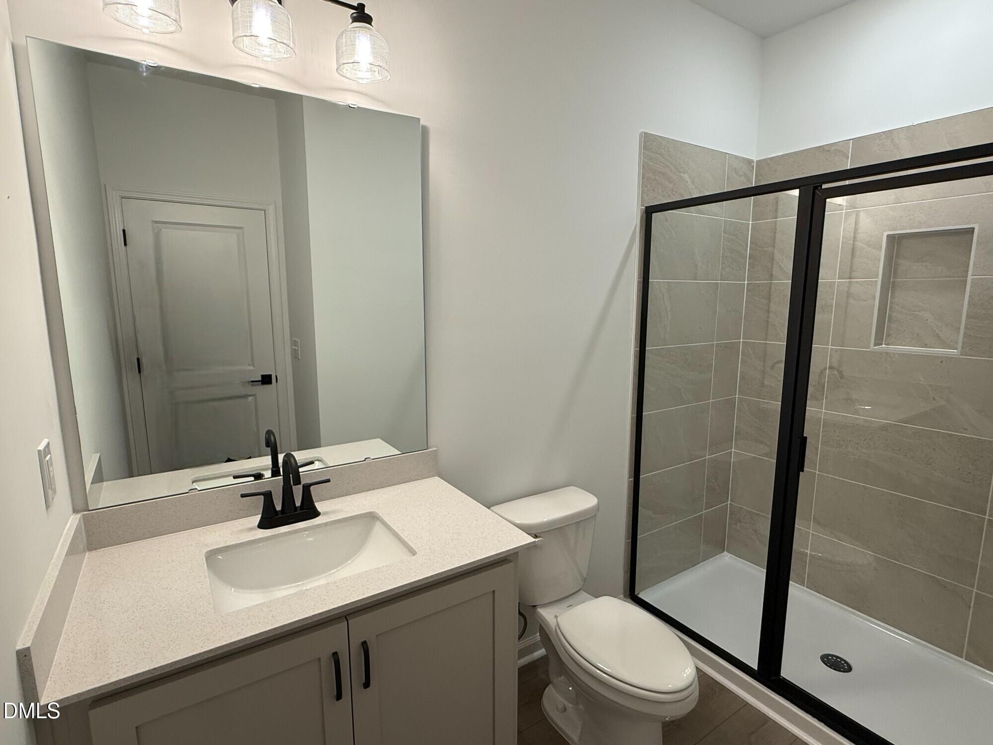 433 Contempo Court, Unit 3 Rolesville, NC 27571 - Photo 14 of 40 a bathroom with a sink toilet and shower