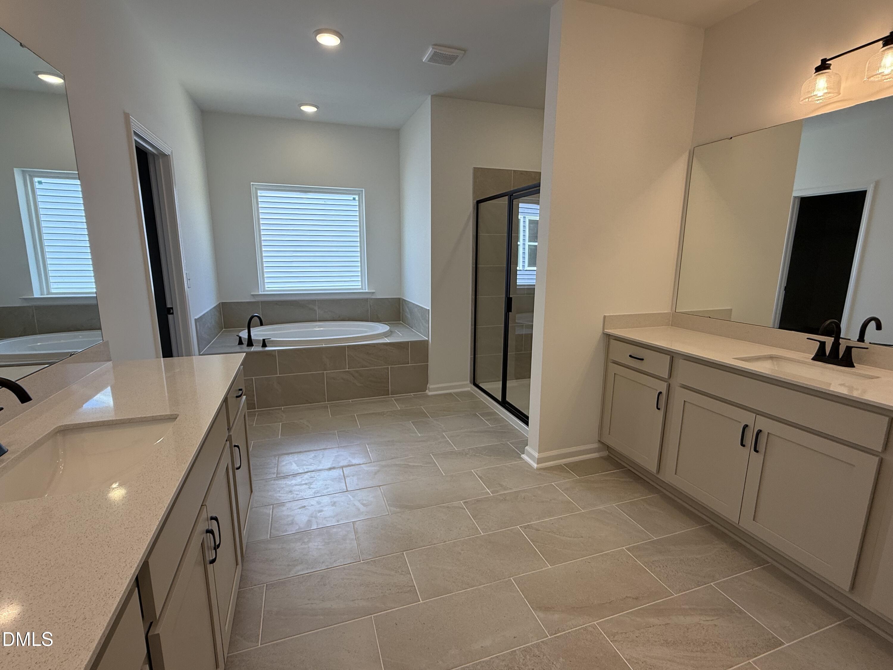 433 Contempo Court, Unit 3 Rolesville, NC 27571 - Photo 18 of 40 a bathroom with a tub sink and mirror
