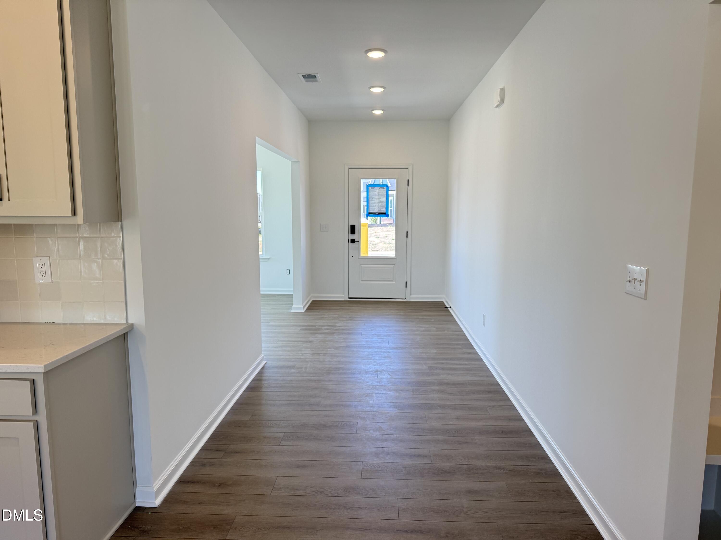 433 Contempo Court, Unit 3 Rolesville, NC 27571 - Photo 2 of 40 a view of a hallway with wooden floor
