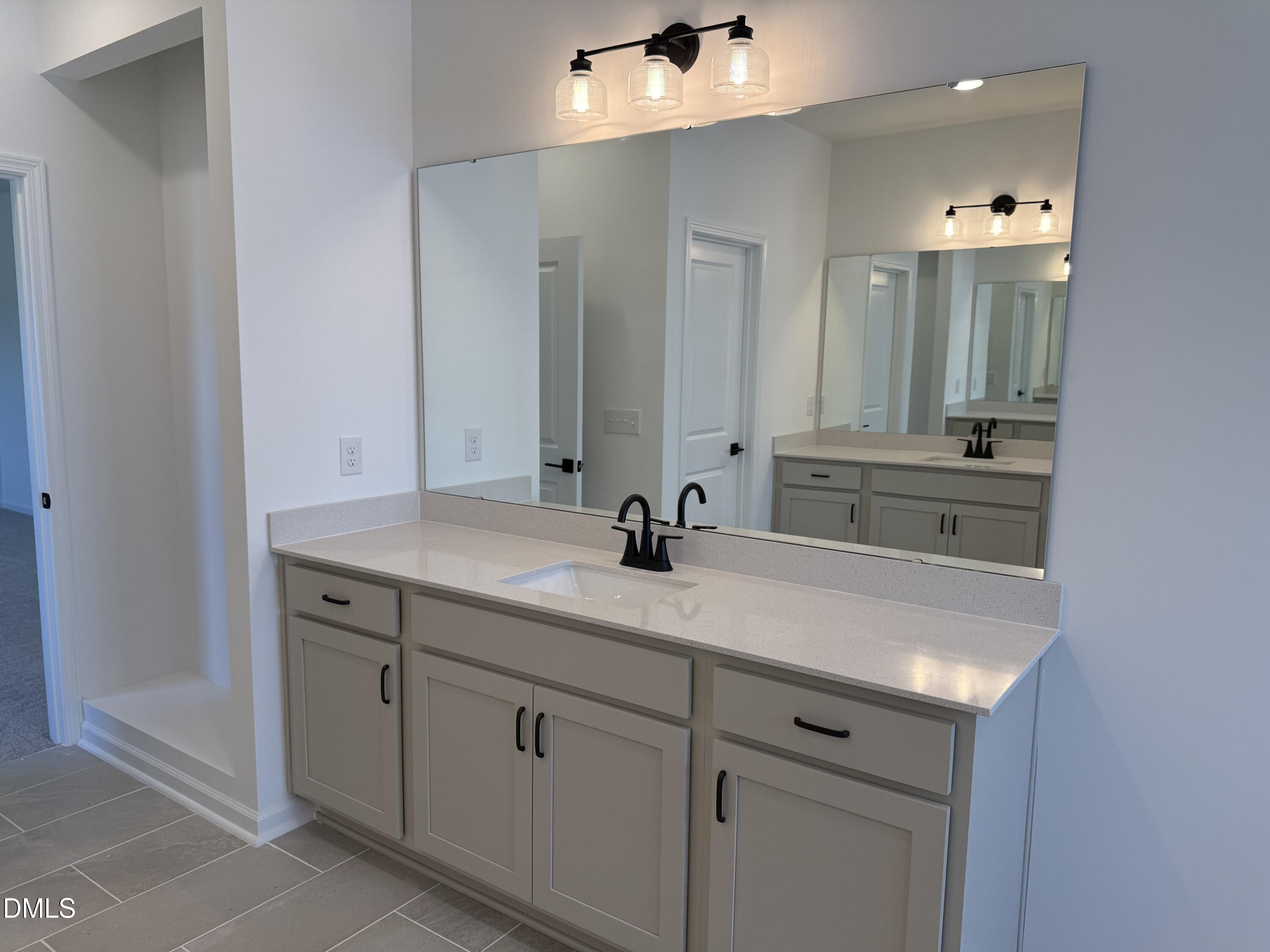 433 Contempo Court, Unit 3 Rolesville, NC 27571 - Photo 21 of 40 a bathroom with a sink and a mirror